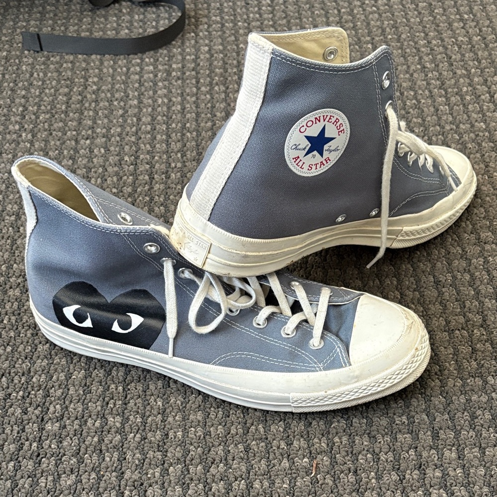 Gray Comme des Garcons Converse high-tops.
